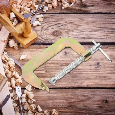 Hefty 6 Inch C Clamp For Woodworking And Welding Made From Heavy Duty Heat Treated Carbon Steel with T handle on wooden table