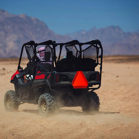 UTV with Two Pack Slow Moving Vehicle Signs With Mounting Brackets For Golf Carts Tractors And UTVs 14 By 16 Inch Diamond Grade Reflective 80 Mil Outdoor Safety Signs No Hassle Hardware Included For Quick Install in desert terrain.