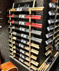 Wall Mounted Drum Stick Holder And Display Rack Heavy Duty Acrylic Organizer For Ten Pairs Of Drumsticks and Lightsabers Keeps Your Studio Rig Fresh Top Shelf Zero Clutter with red and natural drumsticks.