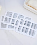 10 Piece Pack Disposable Shower Drain Catcher 3.9 Inch Silver Mesh Filter for Tub and Sink laid out on a surface.