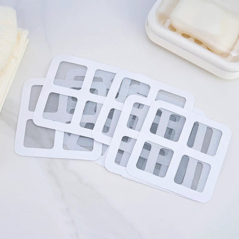 10 Piece Pack Disposable Shower Drain Catcher 3.9 Inch Silver Mesh Filter for Tub and Sink laid out on a surface.