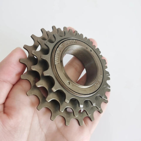Hand holding Three Speed Bike Freewheel 16 19 22 Teeth For Most Bikes Threaded Freewheel Replacement Part, brown finish
