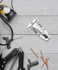 Stainless Steel Truck Door Hinges For Box Trucks And Trailers on a workbench with tools and accessories.
