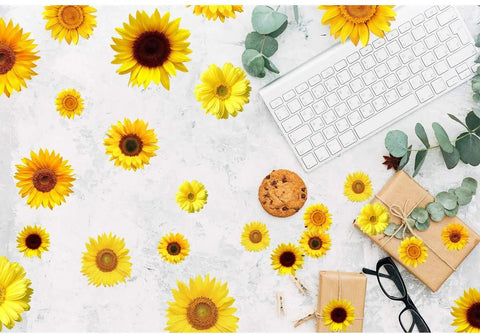 72 Pieces Sunflower Wall Sticker Set Peel And Stick 3D Removable Waterproof Decals scattered on marble surface with keyboard and gifts