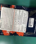 Back of a packaged product with text labels and instructions on a teal surface.