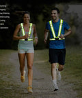 Two people jogging outdoors wearing Reflective Running Vest 2 Pack High Visibility Gear For Cycling Jogging Walking Adjustable Safety Vests.