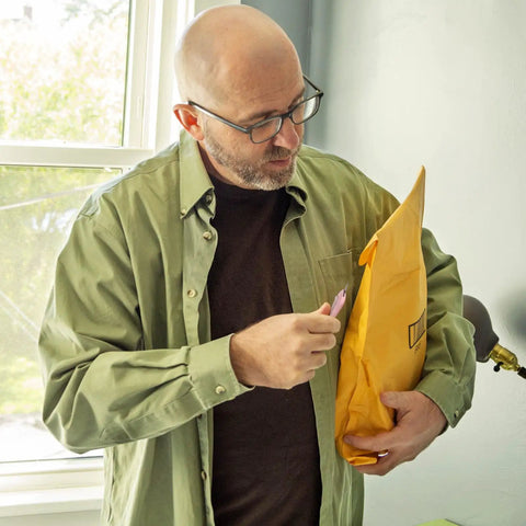 Man using Ultra Sharp Retractable Box Cutter Set For Grab And Go Box And Envelope Opening on package