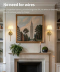 Legit Dope Gold Cordless Wall Sconces Set Of Two With Soft Beige Fabric and Warm LED lighting near a painting above a fireplace.