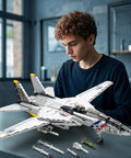 Person assembling F-14 Fighter Jet Building Set With Movable Wings, Realistic Military Plane Model Kit For Adults in modern room