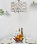 Briolette 16 Inch Four Light Crystal Chandelier With Round Beaded Drum Shade Adjustable Height Chrome Finish over dining table