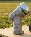 Close-up of Beefy Gearbox Drive Head Assembly for Grass Trimmer in aluminum and steel construction on grass