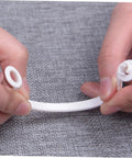 Hands holding a white plastic curtain ring from 60 Pack Plastic Circular Curtain Rings For Rods With Smooth Glide No Burr.