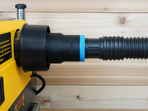 Top Shelf Dust Collection Hose Adapter Fits DW735 Series Planers attached to vacuum hose, designed for clean woodworking jobs.