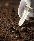 Go To Seed Spreader And Sowing Tool For Gardeners with ergonomic design, shown in hand sowing seeds into soil in outdoor setting.