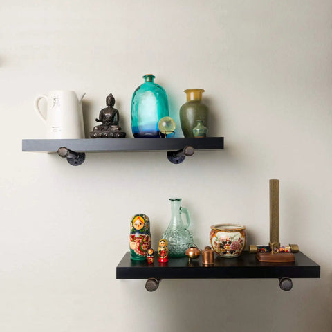 Hella Sturdy Half Inch Industrial Black Iron Pipe Shelf Brackets holding decorative items on wall mounted shelves.