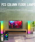 Two Pack RGB Floor Lamps With Music Sync App Control And Time Settings in a living room with TV and remote control visible