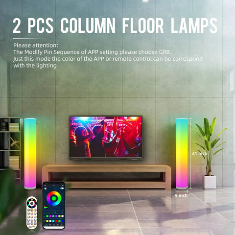 Two Pack RGB Floor Lamps With Music Sync App Control And Time Settings in a living room with TV and remote control visible