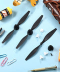 Three Piece Spare RC Plane Propeller Kit With Carbon Fiber Nose Cone And Adapters For TR C285G And TR C385 displayed on blue surface.
