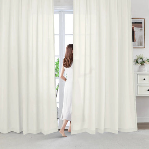 Woman stands between Beige Farmhouse Sheer Curtains 95 Inch Long For Living Room And Bedroom Cozy Light Filtering Semi Sheer Panels 2 Panels Rod Pocket Privacy Drapes For Window Treatment.