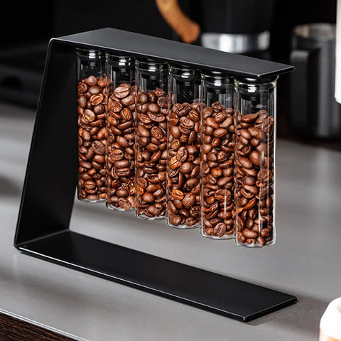 Glass Coffee Bean Storage Tubes Set Of Six With One Way Degassing Valve And Magnetic Stand And Single Dose Espresso Dosing Vials To Keep Your Java Fresh As A Daisy While Handling Your Essential Daily Grind Session, filled with roasted coffee beans.