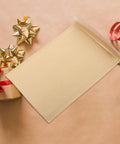 Khaki Kraft Bubble Mailers Set 22x34cm with gold bows and red ribbon on a kraft paper background