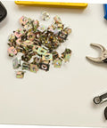 50 Pack Hella Tough U Shape Nut Fasteners For Automotive Body Clips Heavy Duty metal U-nuts on a flat surface with tools.