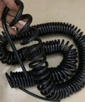 Heavy Duty Retractable Twin Spiral Extension Cord With Four 2.5 Mm Conductors Stretching Up To Ten Meters, coiled and in hand.