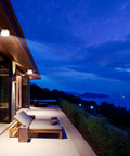 Motion Sensor LED Ceiling Light Flush Mount 20W 1980 Lumens 5000K illuminating an outdoor patio with lounge chairs at dusk