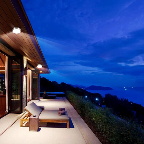 Motion Sensor LED Ceiling Light Flush Mount 20W 1980 Lumens 5000K illuminating an outdoor patio with lounge chairs at dusk