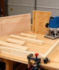 Adjustable Juice Groove Router Jig With 8 Spacers Wooden Router Guide on workbench with cutting boards and power tool