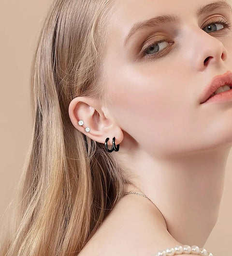 Matte Black Earring Set For Piercings Includes 7 Flat Back Stud Earrings And 4 Small Hoop Earrings In Titanium And Surgical Steel Black CZ Pearl Ball Opal Accents Lightweight Dope Dainty Jewelry For Cartilage Helix And Multiple Piercings, model wearing hoops and studs