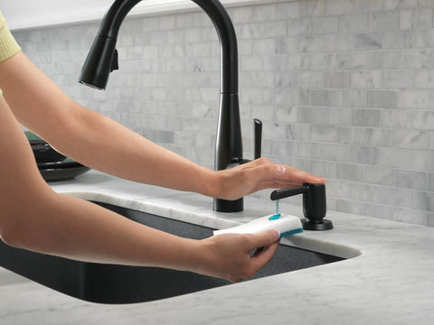 Hands using Essa Kitchen Faucet Soap Dispenser Accessory Matte Black With Metal Construction, Refills From Above Deck on marble countertop