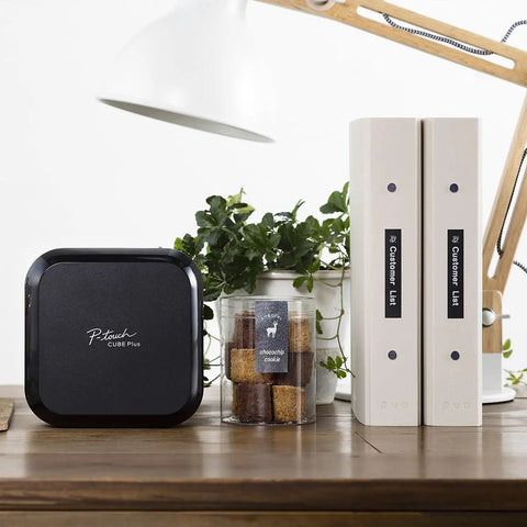 P-Touch CUBE Plus Bluetooth Label Maker PT-P710BT Portable Label Printer on desk with binders and plants