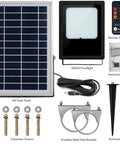 JUDYSSY Solar Floodlight Outdoor kit featuring 6W solar panel, 120 LED floodlight, remote, stainless steel parts, and aluminum spikes.