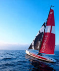 53 Inch Remote Control Sailboat Kit With Pre Assembled Sail Accessories sailing on open water at sunset