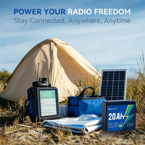 12V 20Ah LiFePO4 Deep Cycle Battery with 20A BMS for solar systems and camping gear next to tent and solar panel outdoors.