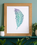 Awesome Boho Feather And Mandala Stencil Set, floral feather art print in a wooden frame against a green wall.