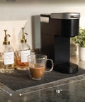 Absorbent Coffee Mat For Countertops 12 By 18 Inch Spill Catcher Pad under coffee maker with syrups and cup.