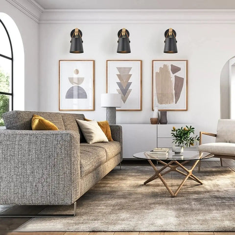 Living room with set of two modern wall sconces with E26 base, wood and leather look, above sofa, soft glow lighting.