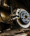 Installed Universal 18-Inch Rubber Brake Hose, 3/8-24 External To 3/8-24 Internal Threads, on vehicle brake system close-up