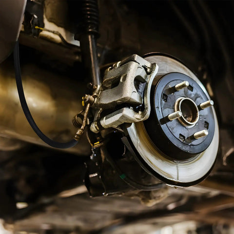 Installed Universal 18-Inch Rubber Brake Hose, 3/8-24 External To 3/8-24 Internal Threads, on vehicle brake system close-up