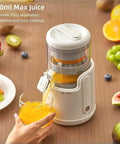 Cordless Electric Citrus Juicer For Lemons And Oranges With Rechargeable Battery pouring fresh orange juice into glass