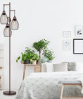Dimmable Farmhouse Industrial Floor Lamp With Teardrop Cage Head, 70 Inch, in a bedroom with brown finish and plants