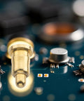 Heavy Duty Spring Loaded Contact Pin With Pointed Tip And 2 Amp Rating snaps snugly into a circuit board, showcasing gold finish.