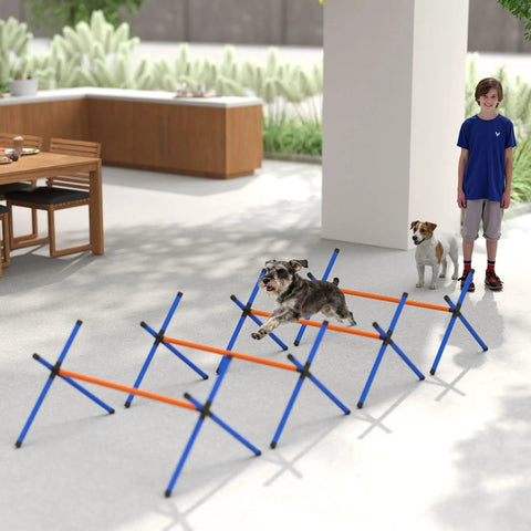 4 Piece Dog Agility Course Set With Adjustable Height Hurdles in use indoors, small dog jumping over orange hurdles.