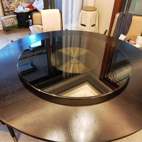 Premium Tempered Glass Lazy Susan Turntable And Slick Swivel Serving Tray on dark wood table, showcasing smooth glass surface.