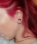 Person wearing Sixteen Millimeter Silicone Flesh Tone Ear Gauges Tunnels Plugs Set With Soft Silicone Double Flare Stretching Kit