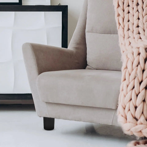 Close-up of a couch corner showing a 4 Pack Round Furniture Leg Replacement Set for Chairs and Tables, Plastic and Metal Design.