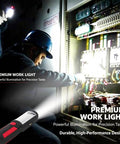 Man using Go To Rechargeable LED Work Light With Magnetic Base And Hanging Hook Portable Waterproof All Purpose Flashlight For Car Repair Home Blackouts And Emergencies Red at a control panel