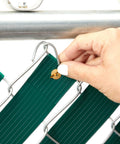 Close-up of hand installing Dark Green PVC Fence Slats For Privacy 1.8 Inch By 246 Feet Privacy Fence Plastic Strips with brass fasteners.